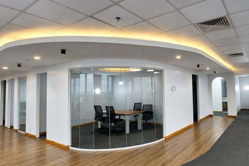 The Ark Associates office at Exchange Tower, Morocco Square, Dar es Salaam, showing the glazed meeting room and open plan work area